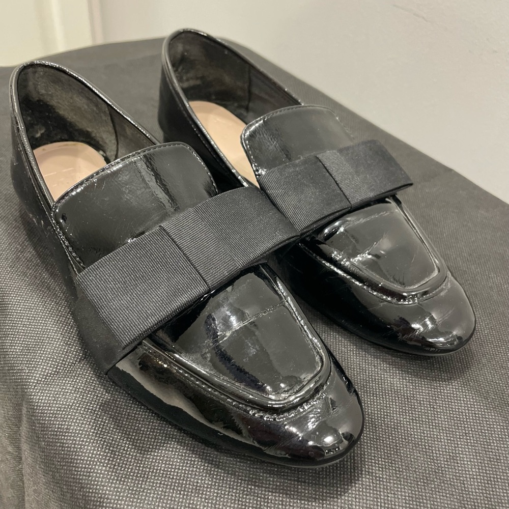 Patton leather black loafers with dramatic bow.